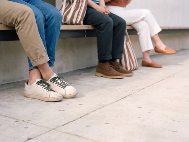 Sneakers, desert boots and loafers on a bench