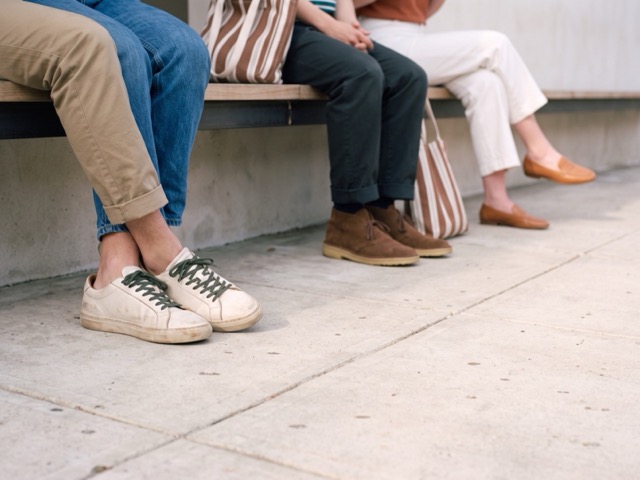 Sneakers, desert boots and loafers on a bench